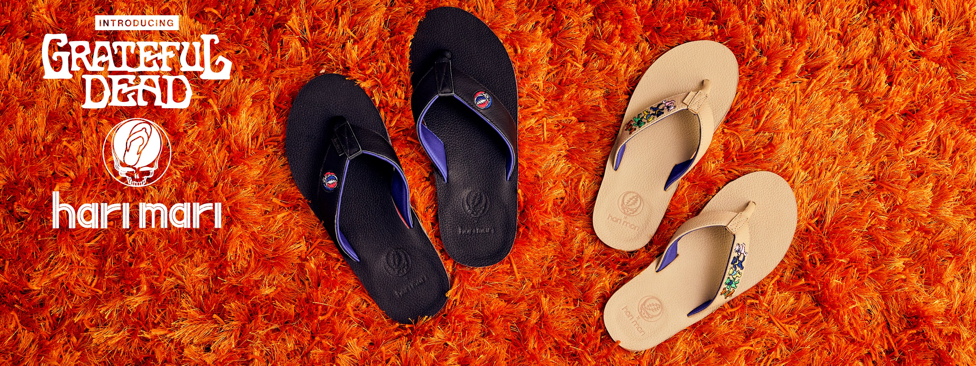 two pairs of grateful dead flip flops on an orange shag rug