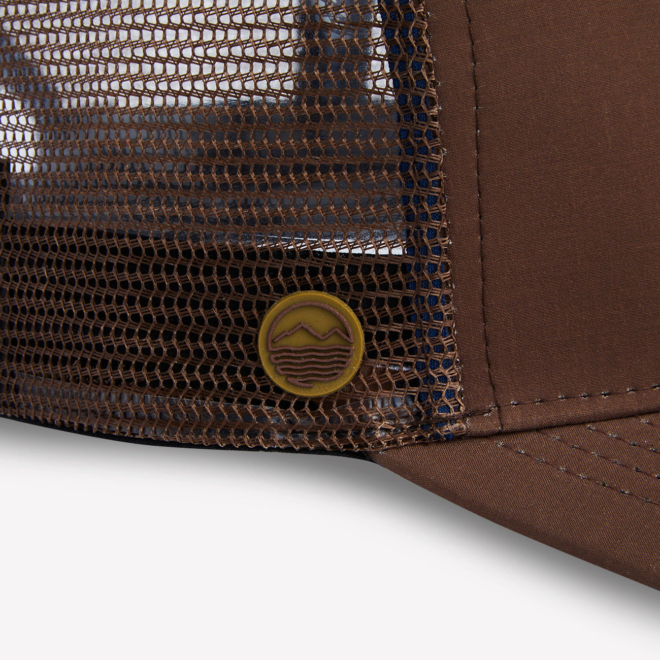 Close up of the Hari Mari logo on brown trucker hat