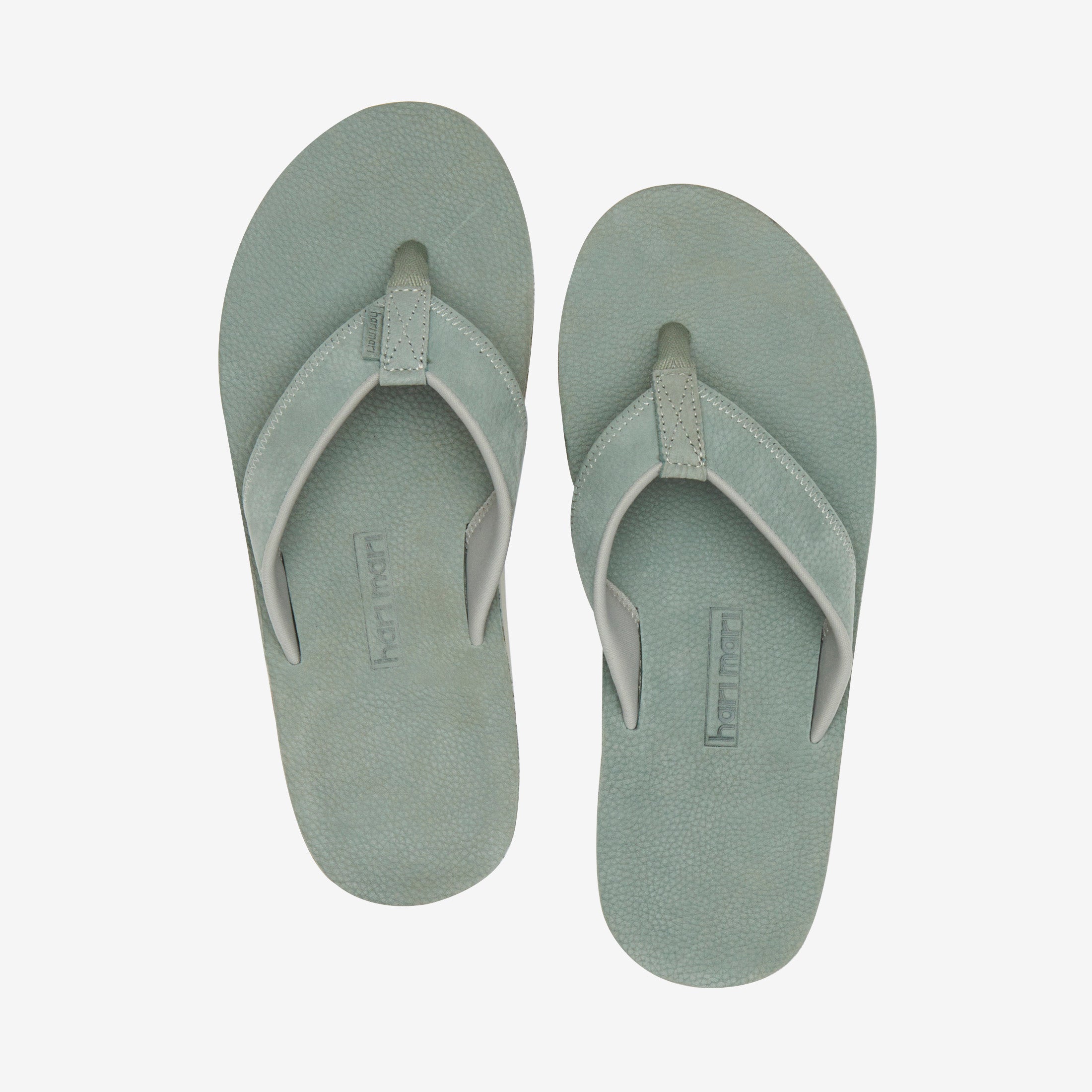 Green leather flip flops from Hari Mari on a white background
