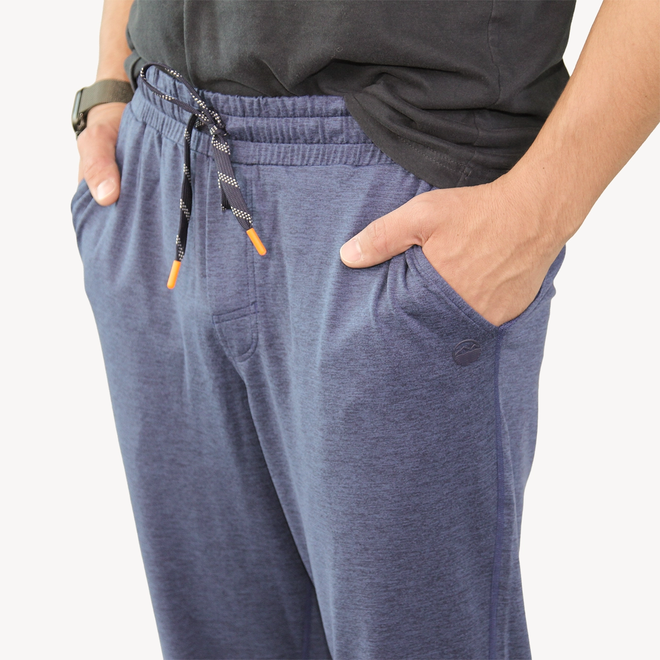 A man wearing dark heather navy Hari Mari drawstring joggers with side pockets.