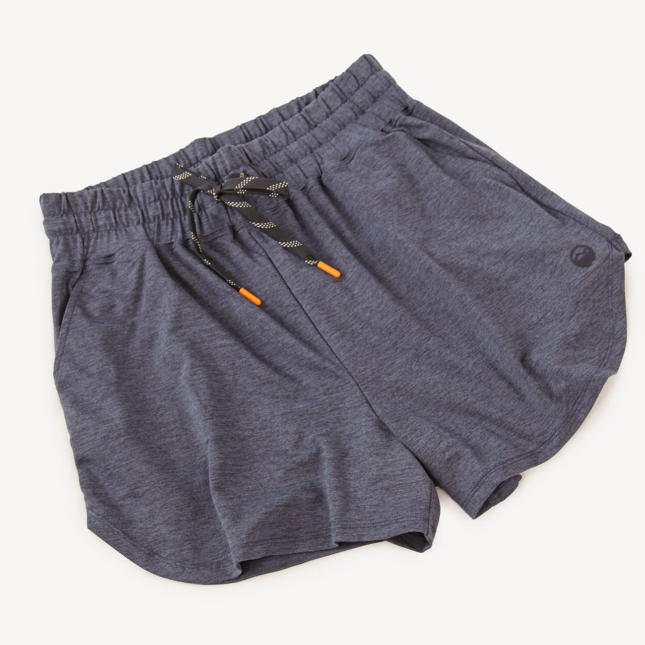A pair of dark heather gray athletic shorts from Hari Mari with an elastic waistband, black and gray drawstring, and small orange accents, shown on a light off-white background.