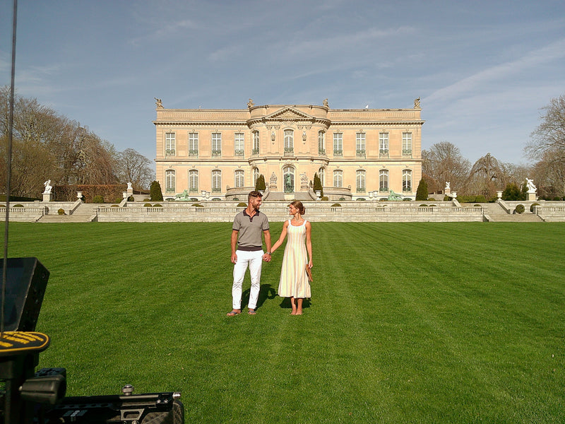 man and woman in front of Newport, RI mansion during a photoshoot
