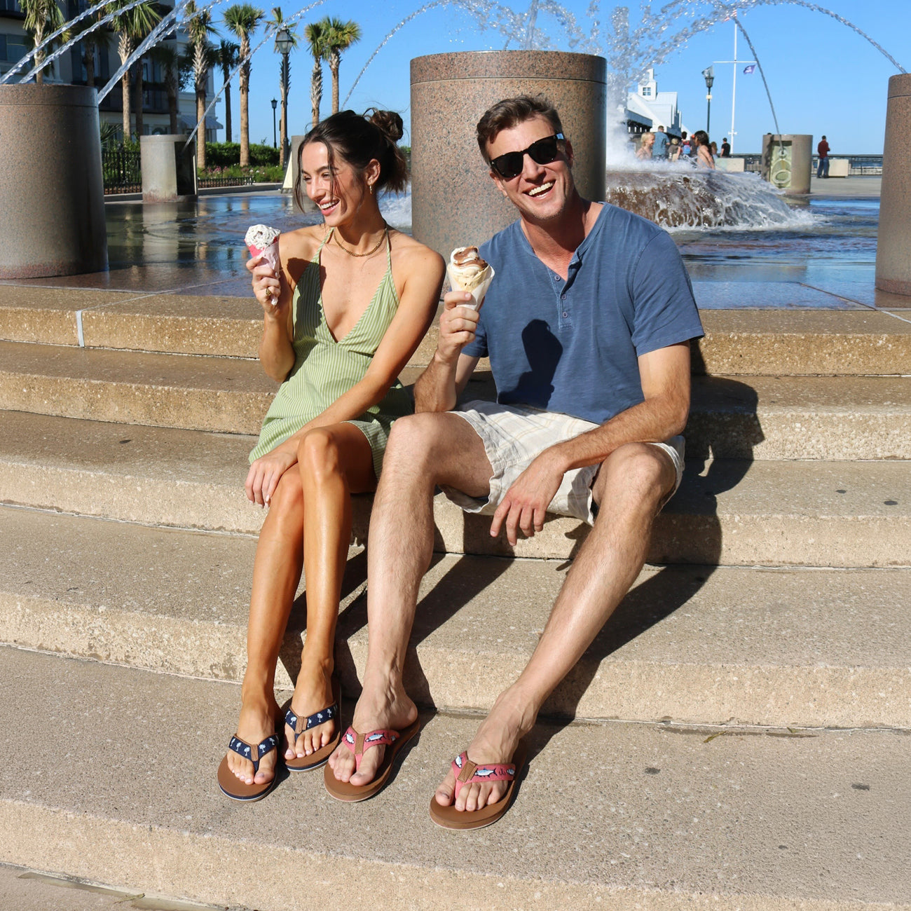 man and woman wearing Shep Rose x Hari Mari flip flops while eating ice cream