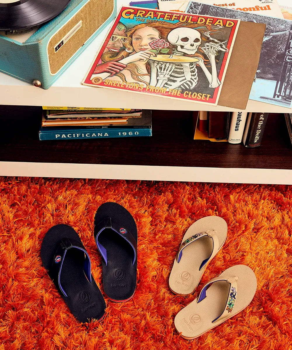 image showing a Grateful Dead record on a record player table with Grateful Dead flip flops on a shag carpet on the floor