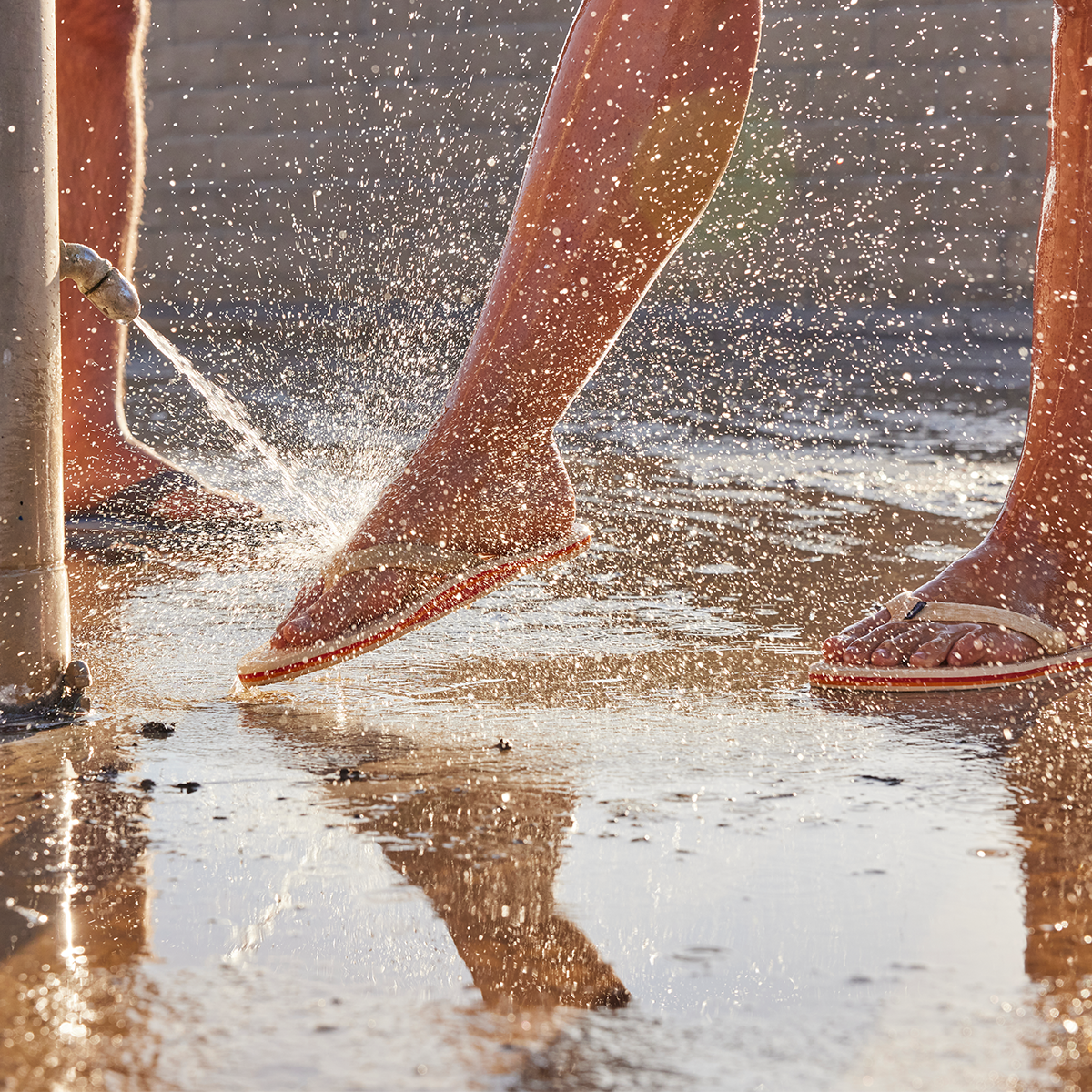 flip flop being rinsed off an the beach