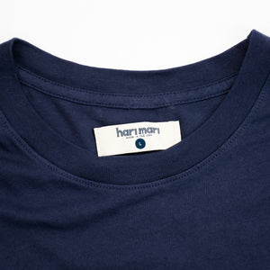 close up of tag in navy tee shirt with white chest graphic