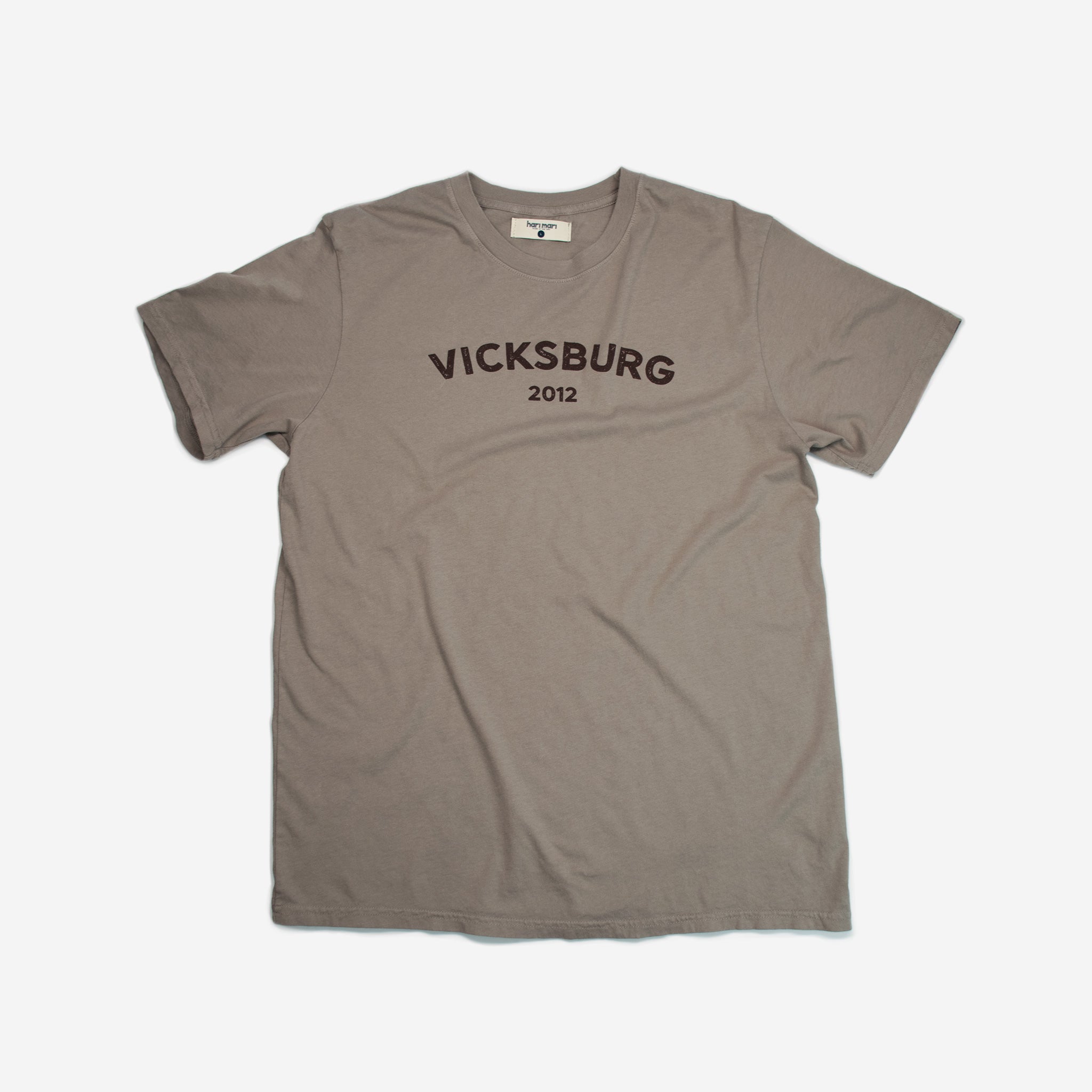 brown tee shirt with maroon graphic on chest