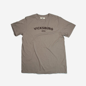 brown tee shirt with maroon graphic on chest