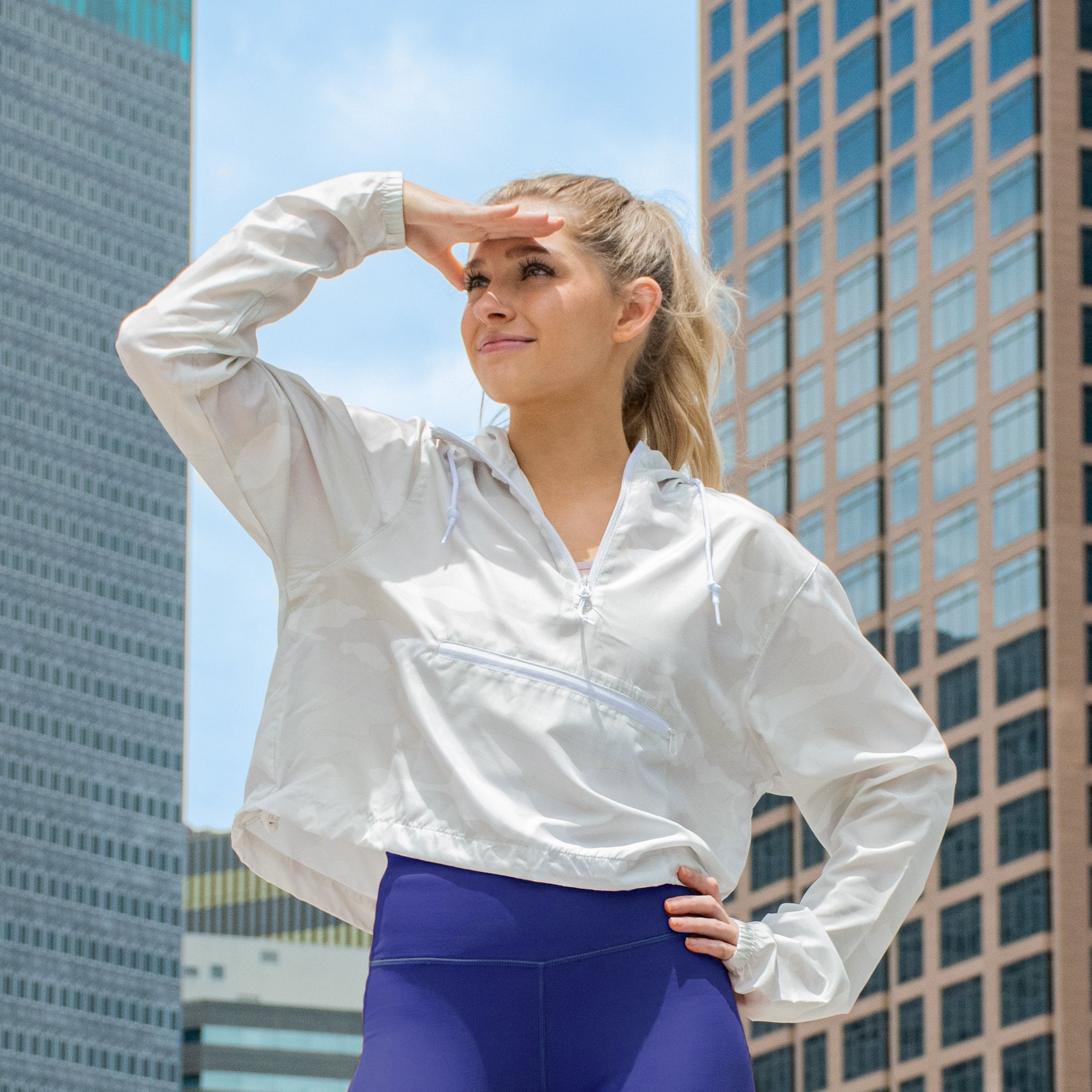 women's white zip up windbreaker on girl in city