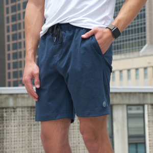photo of man wearing navy Hari Mari shorts in white shirt in downtown area