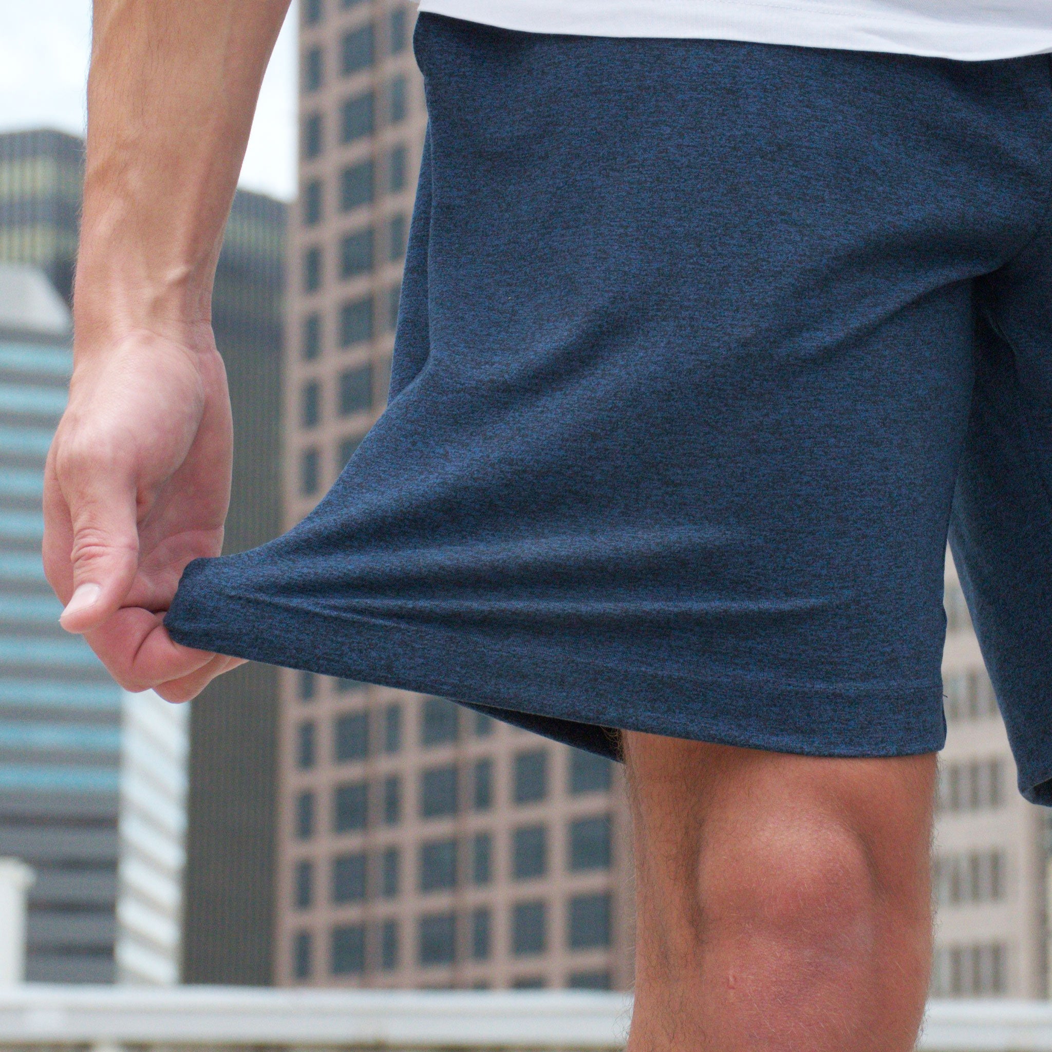 man stretching navy shorts from Hari Mari