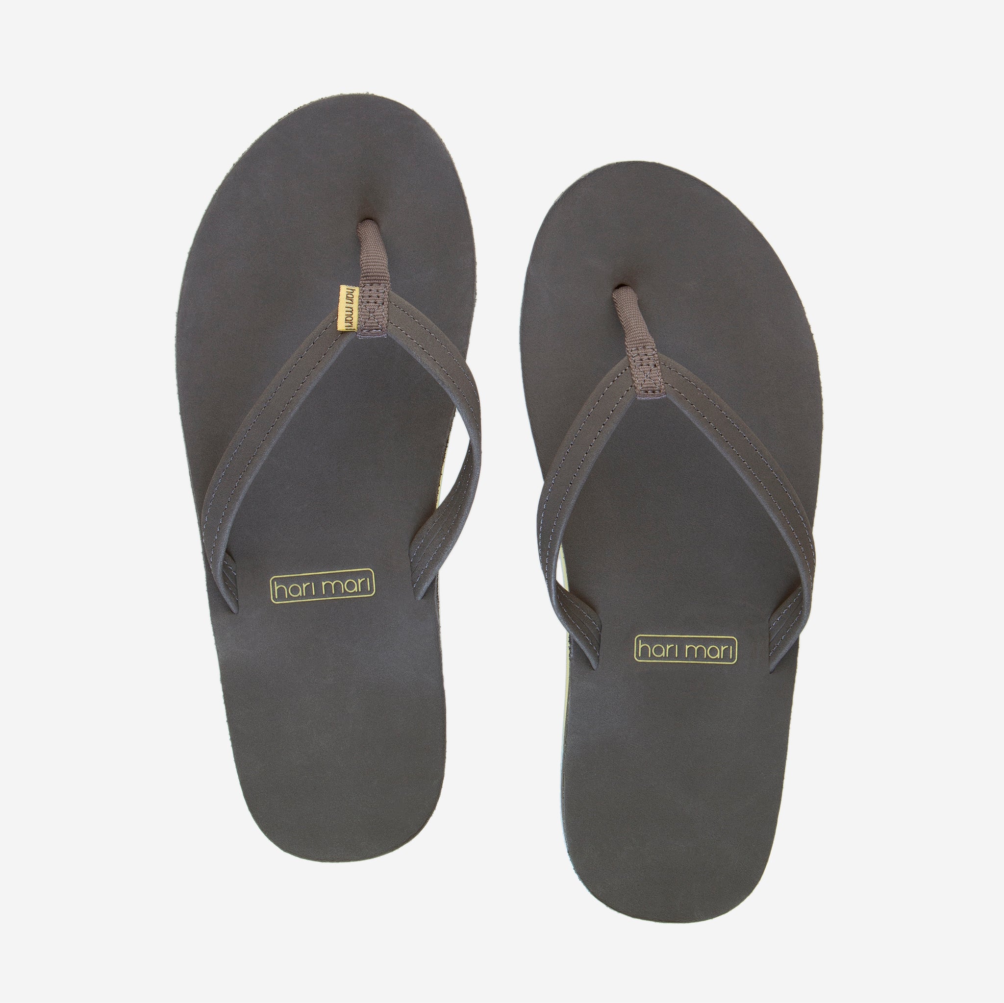 gray and teal women's leather flip flops on white background