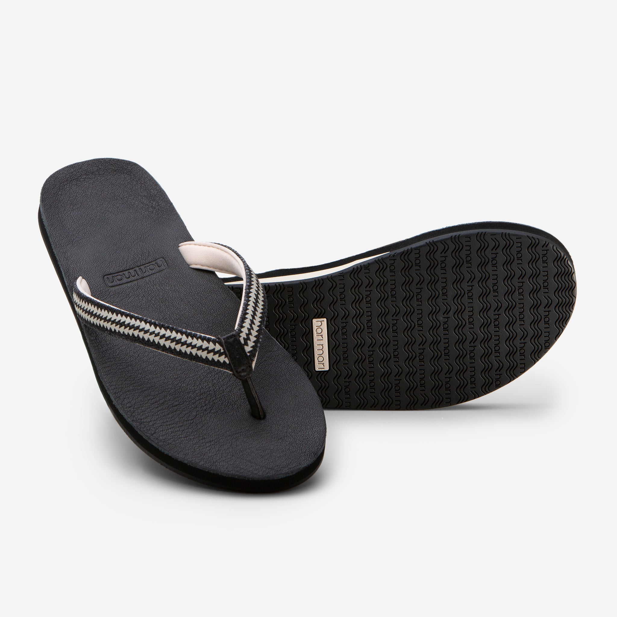 Hari Mari Women's Fields Flip Flop in Black showing flip flop and bottom of flip flop rubber outsole on white background