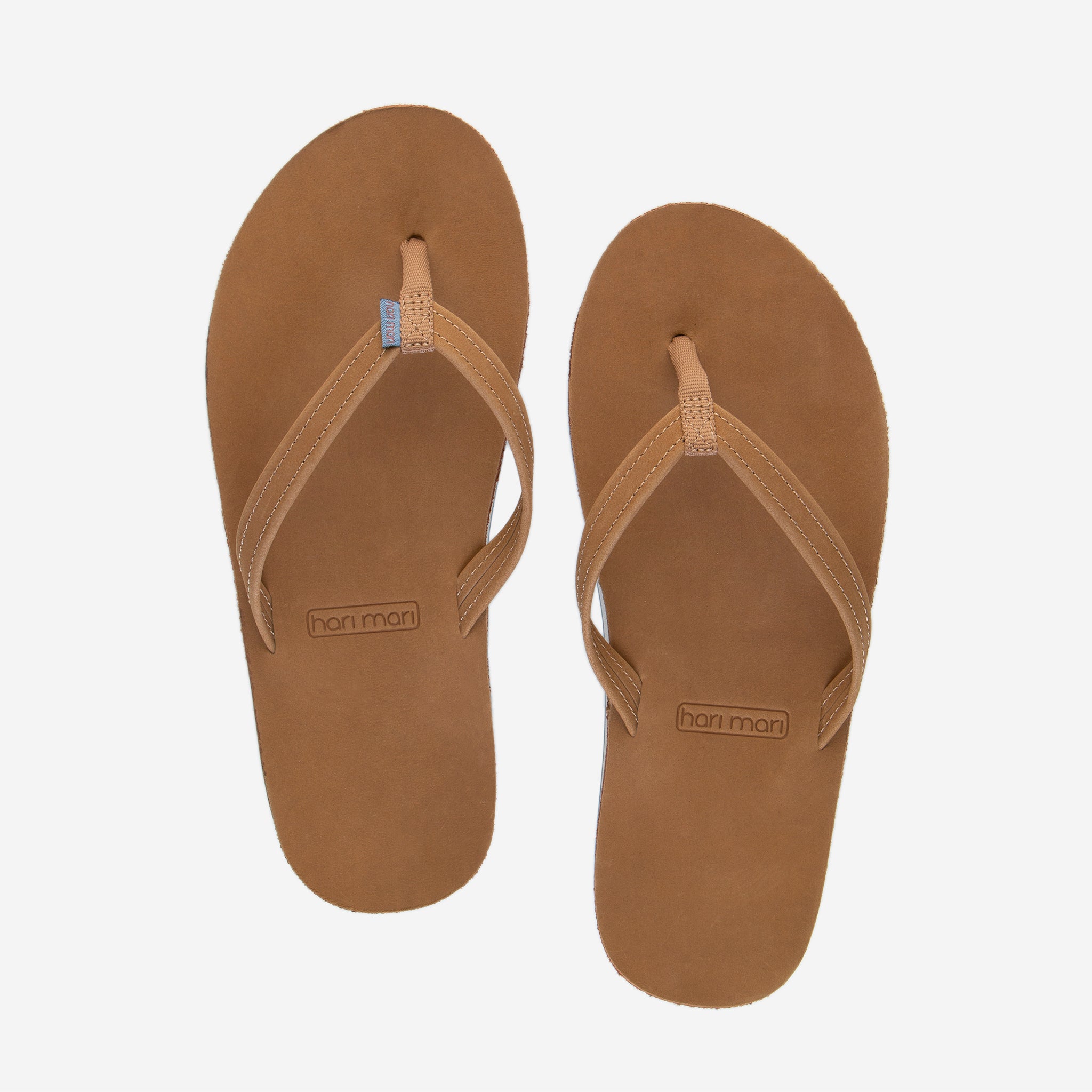 Hari Mari Women's fields flip flops in tan/dusty blue on white background