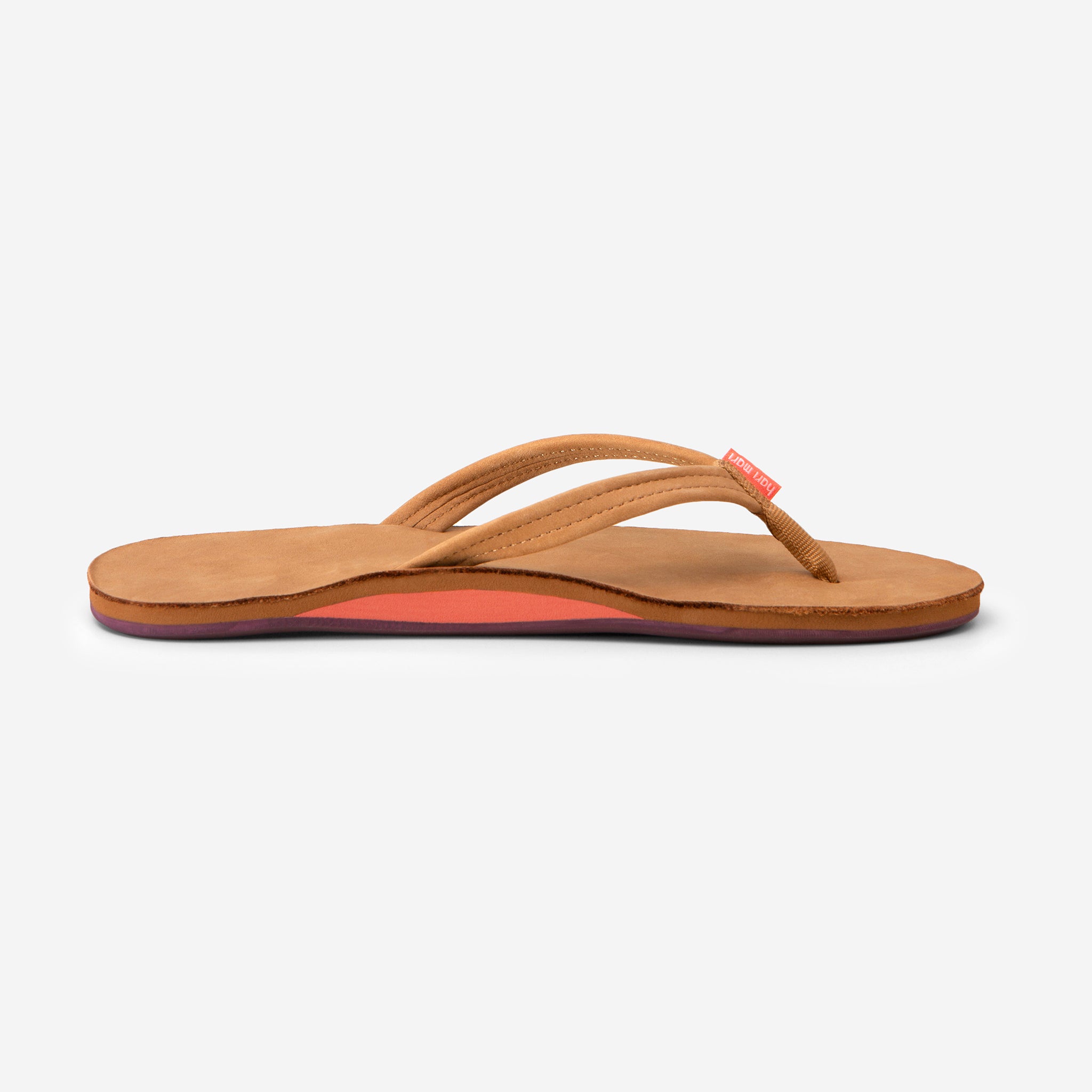 side profile of Hari Mari Women's fields flip flops in tan/fig on white background