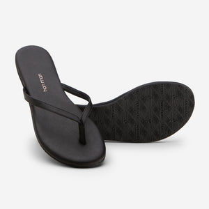Hari Mari Women's The Mari Flip Flop in Black on white background showing flip flop and bottom of flip flop rubber outsole
