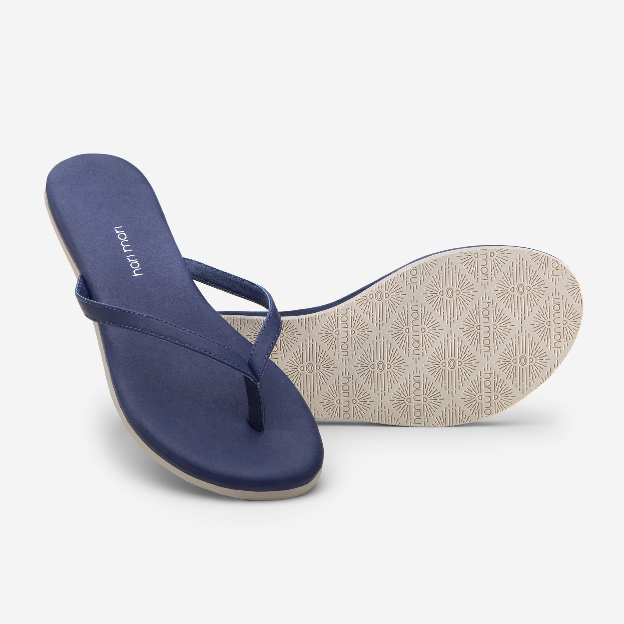 Hari Mari Women's The Mari Flip Flop in Navy on white background showing flip flop and bottom of flip flop rubber outsole